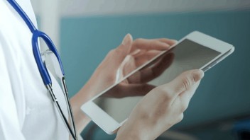 Medical professional on a wireless device using Wi-Fi for hospitals and healthcare